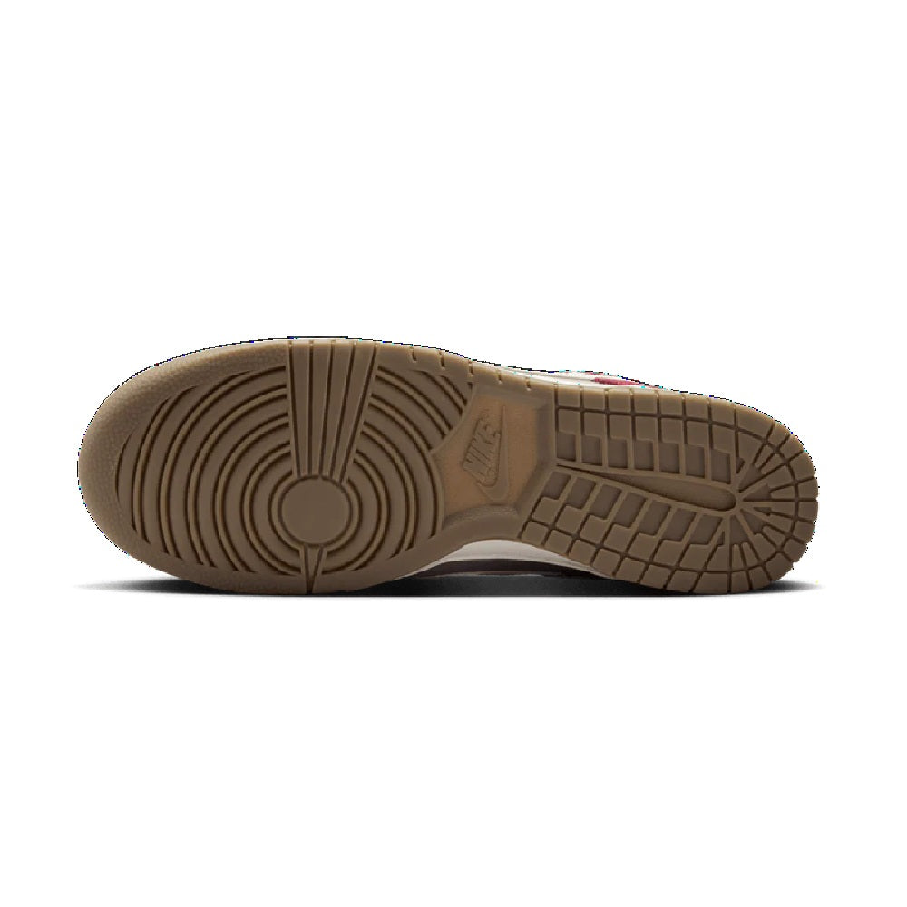 Gum-colored rubber outsole of Nike low-top sneakers with traction tread