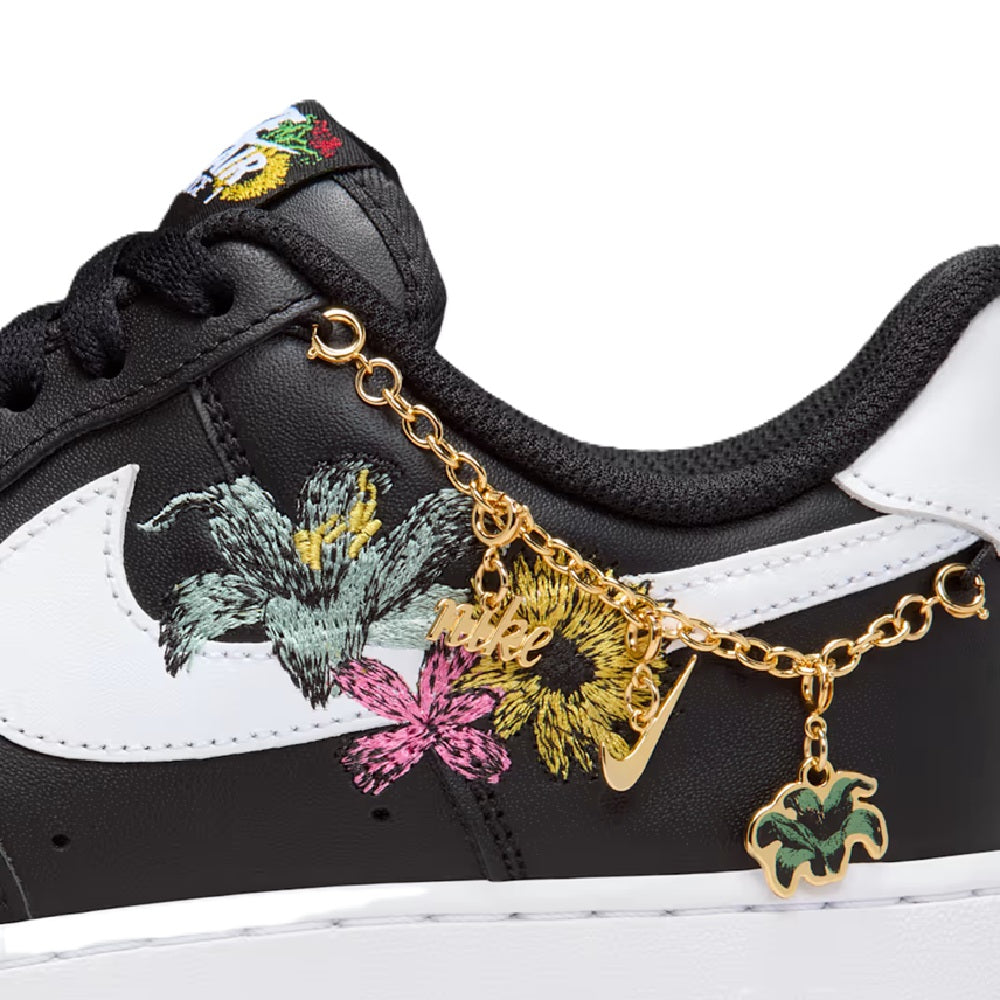 Women's Nike Air Force 1 PRM sneaker close-up: black, white, floral embroidery with gold chain charm