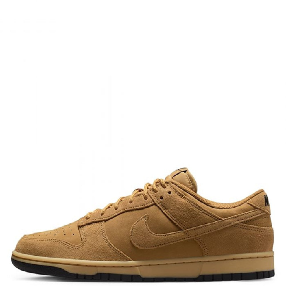 Nike Dunk Low low-top sneakers in tan suede, lace-up with visible Swoosh and black sole.