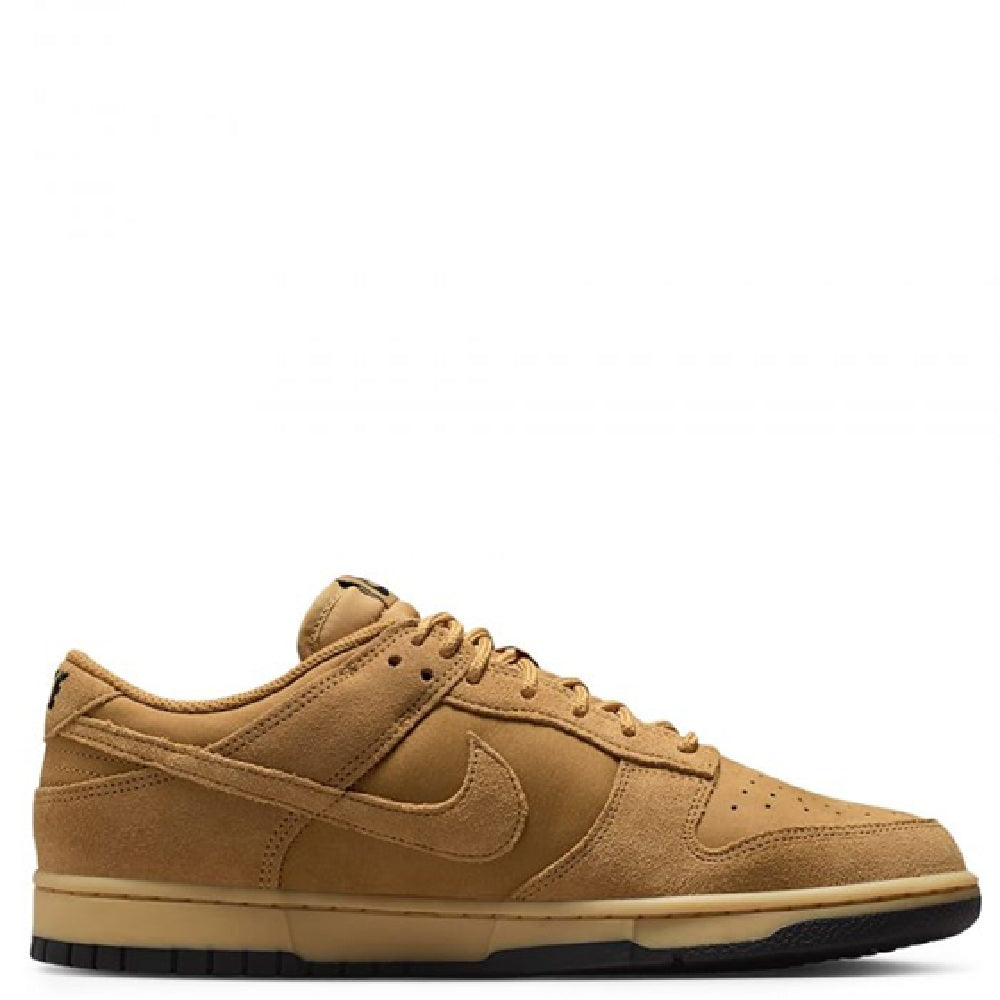 Nike Dunk Low low-top sneakers, tan suede upper and lace-up, side Swoosh detail.