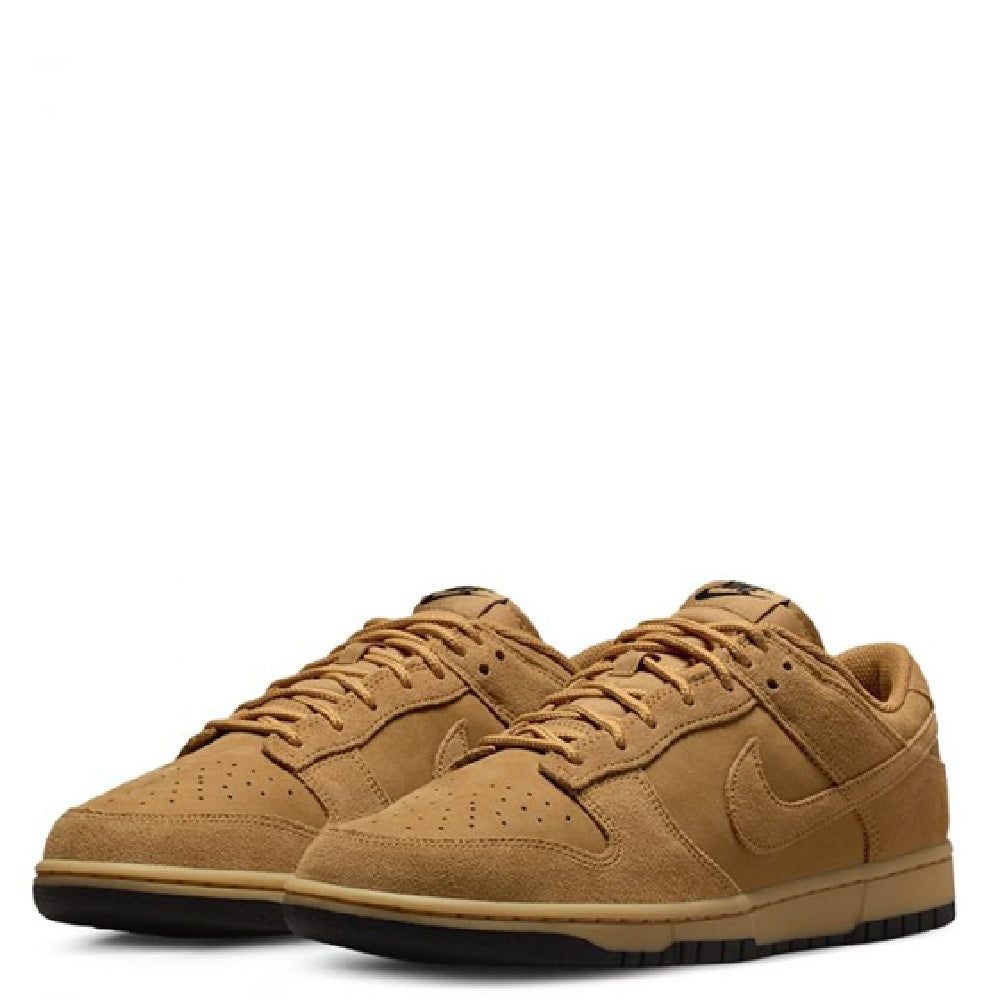 Nike Dunk Low sneakers pair, tan suede with lace-up and perforated toe panels.