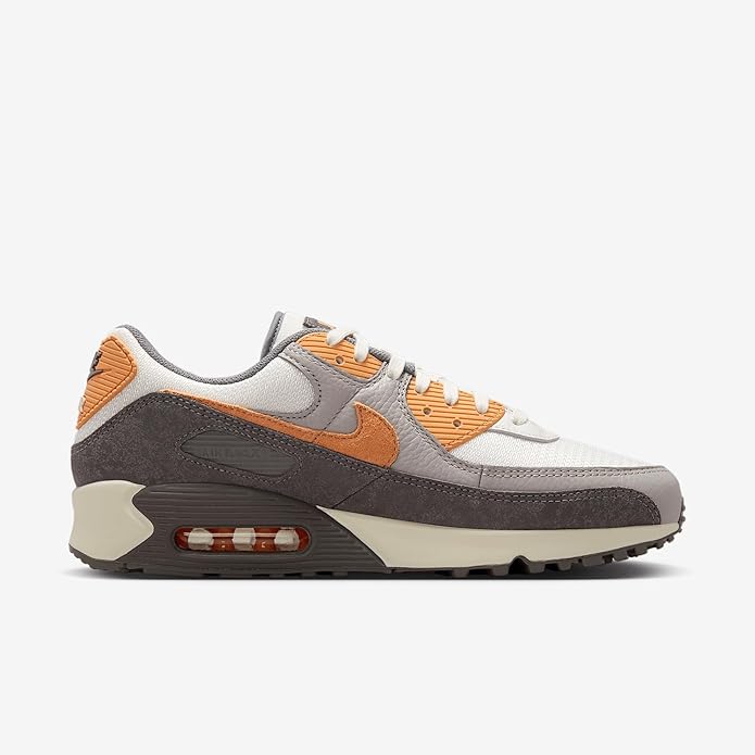 Nike Air Max 90 PRM sneakers, side view with orange swoosh and visible air-cushion window