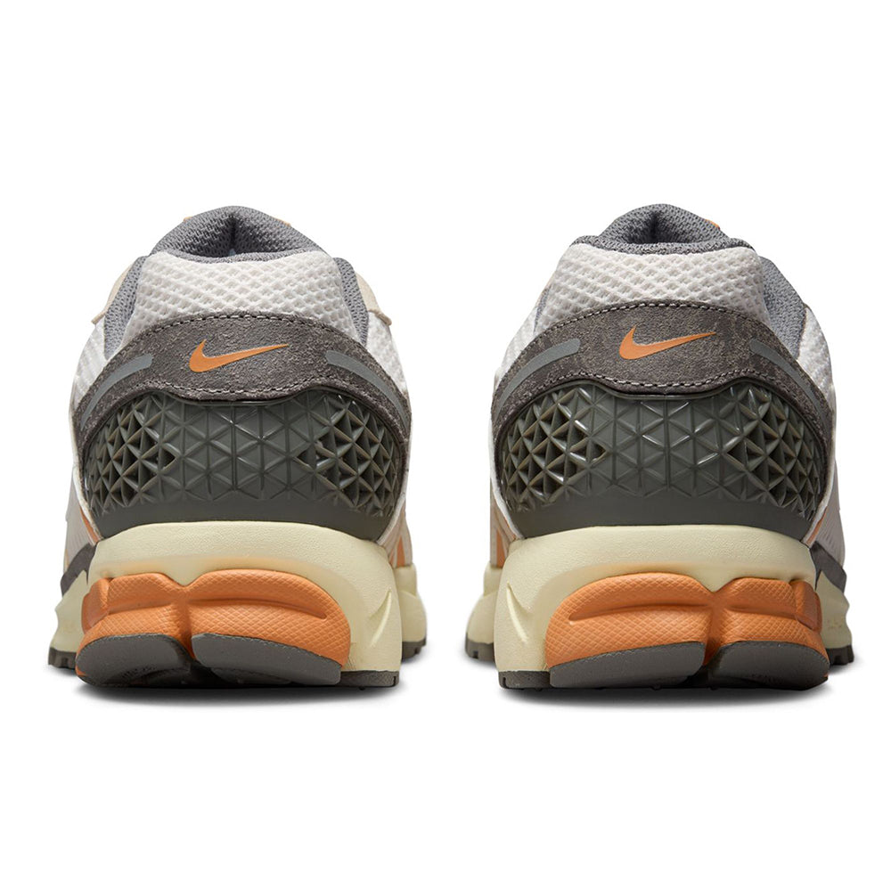 Nike Zoom Vomero 5 sneakers back view with gray heel, orange detailing, and cream midsole