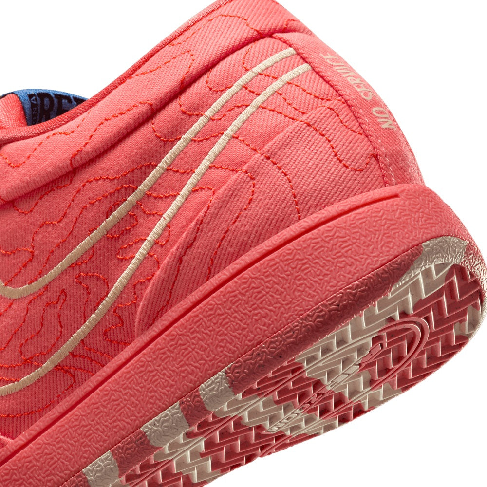 Red Nike sneaker outsole and side stripe detail with traction tread