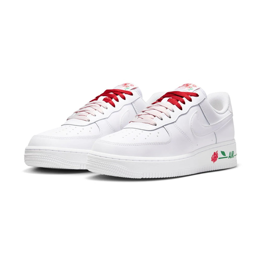 Pair of white low-top sneakers with red laces and red rose prints on the uppers