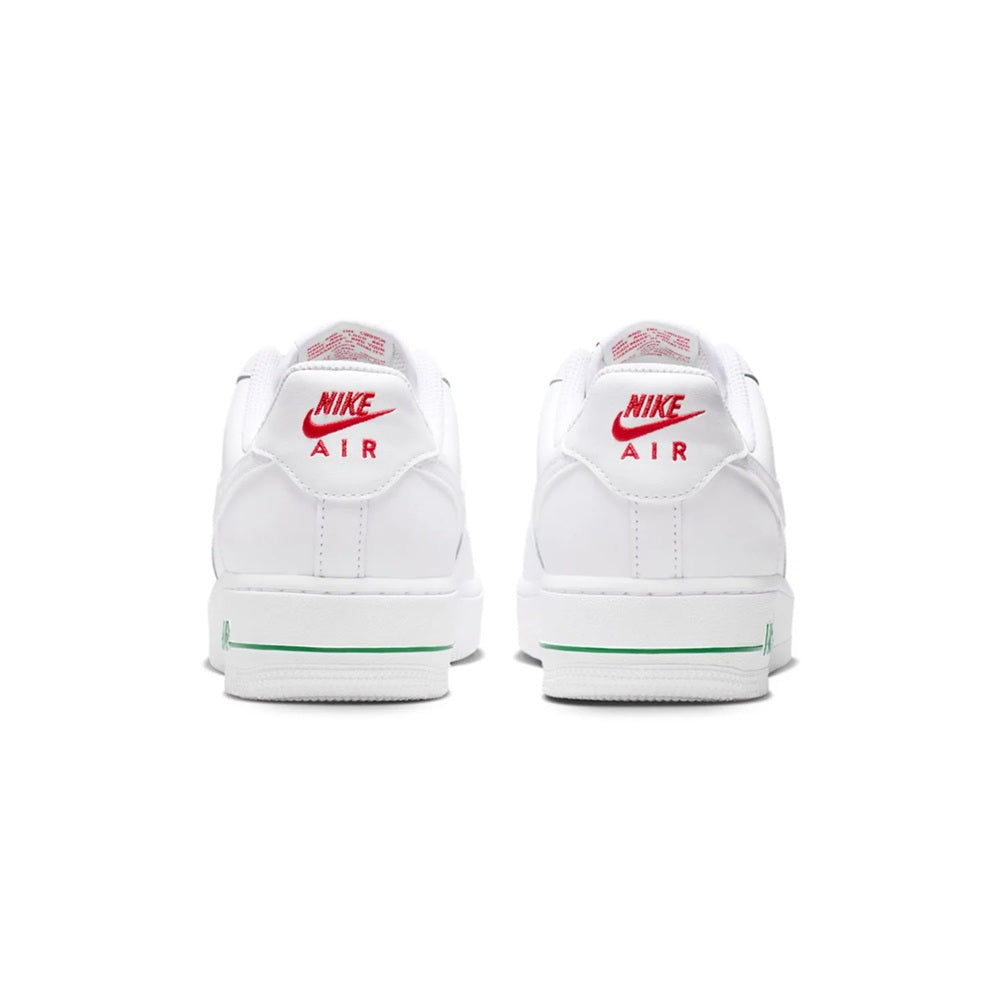 White sneakers with heel Nike Air branding and green stripe trim along the sole