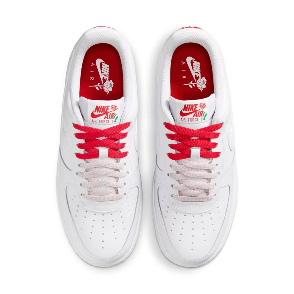 White low-top sneakers with red interior lining, Nike Air logo, and red lace detailing