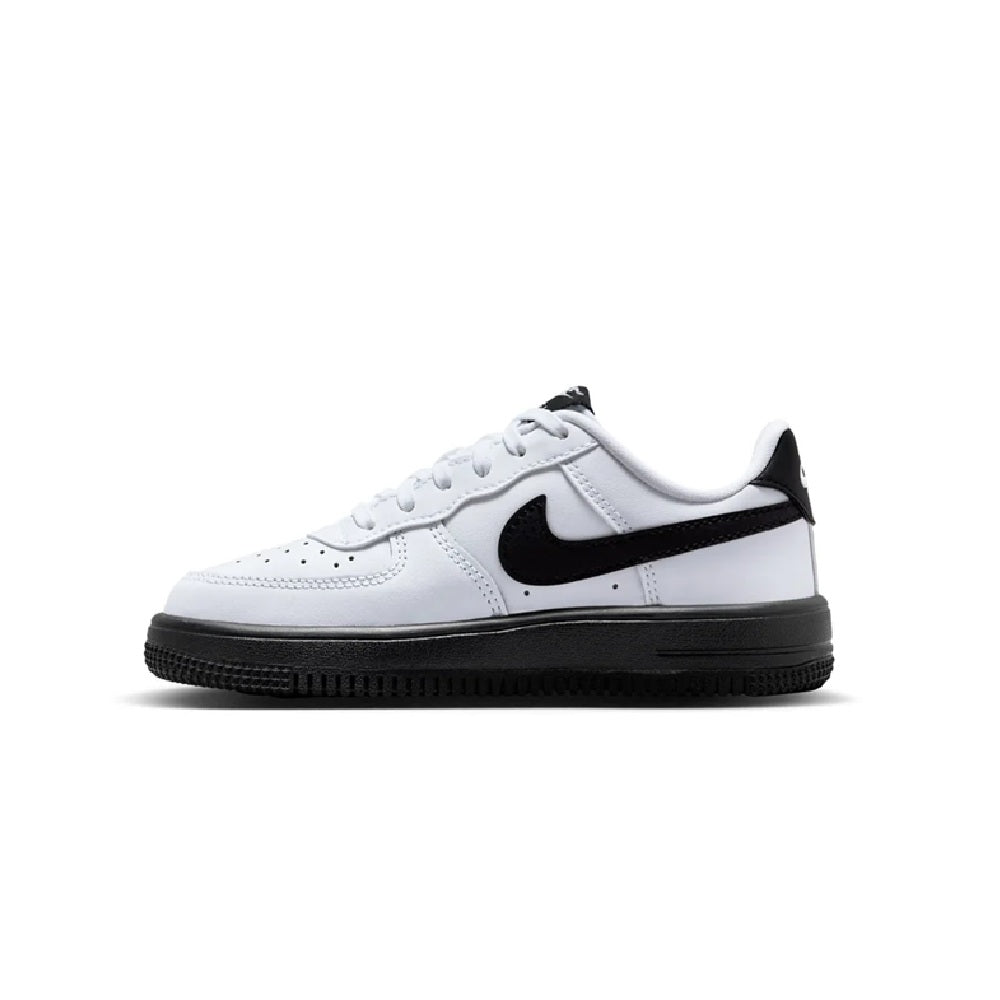 Kids' white low-top sneakers with black swoosh, lace-up front, and dark rubber sole