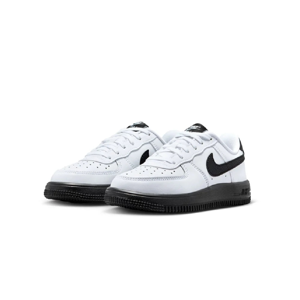 Pair of kids' white Nike low-top sneakers with black swoosh and black textured outsole