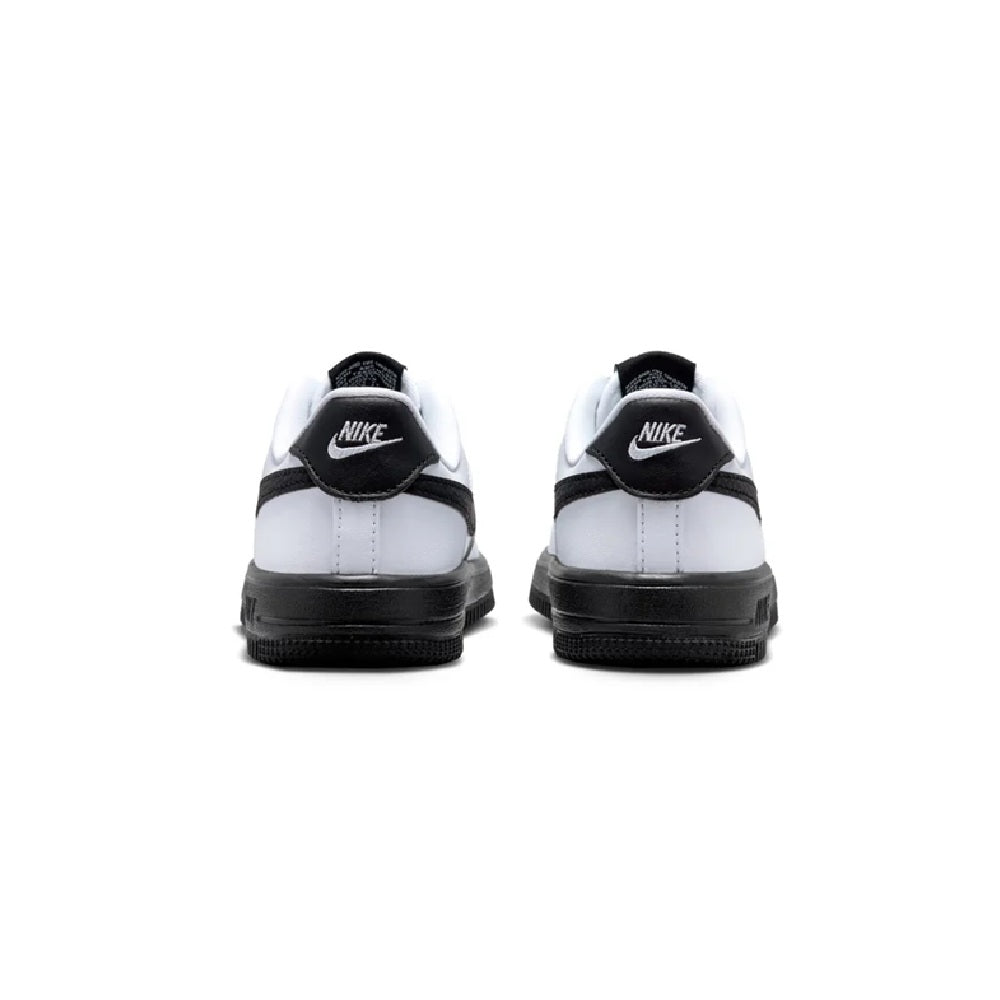 Kids' Nike white and black sneakers, rear view with heel tabs and black rubber outsole