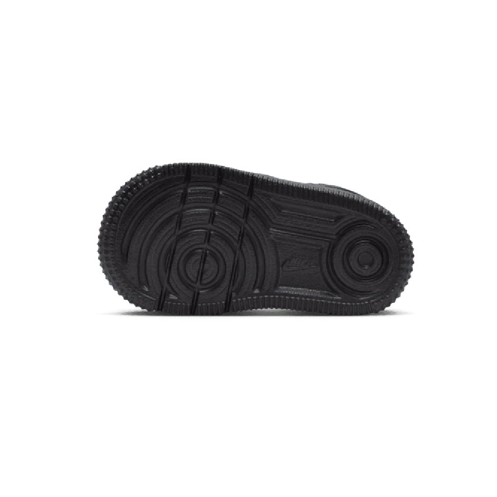 Toddler's black Nike low-top sneaker outsole with deep tread and circular logo