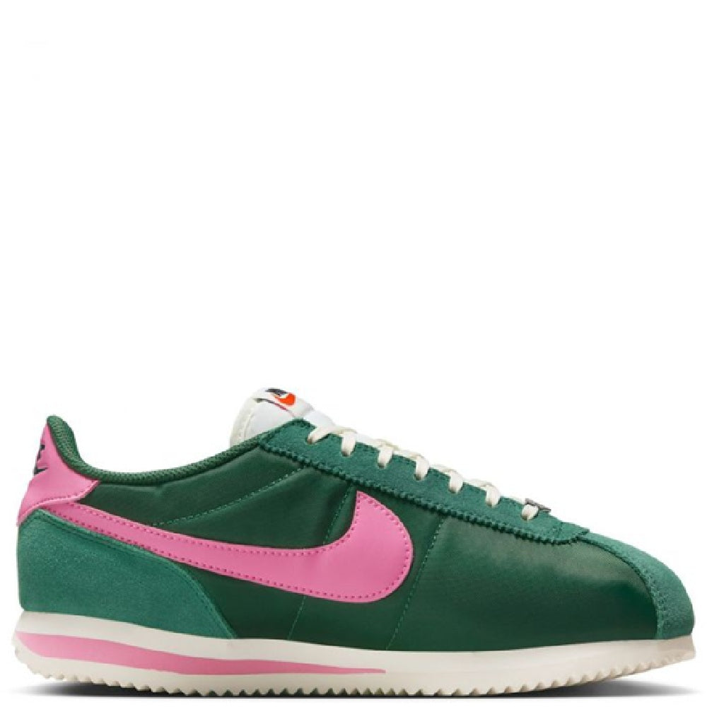Nike Cortez sneakers side view, green suede with pink swoosh and white laces