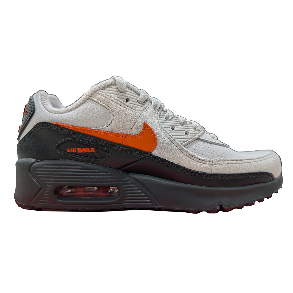 Air Max 90 SE sneaker side view, white upper with orange swoosh and black midsole
