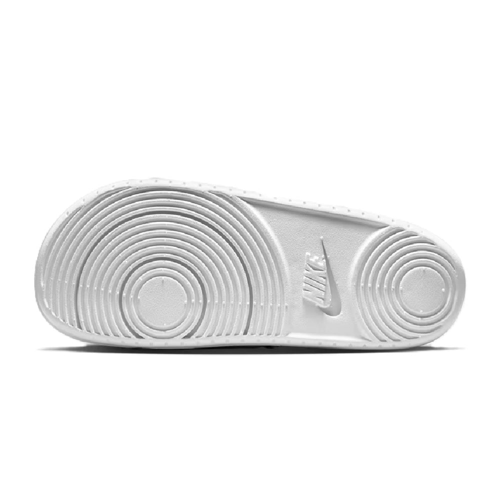 White slide sandal outsole with circular traction pattern and Nike logo