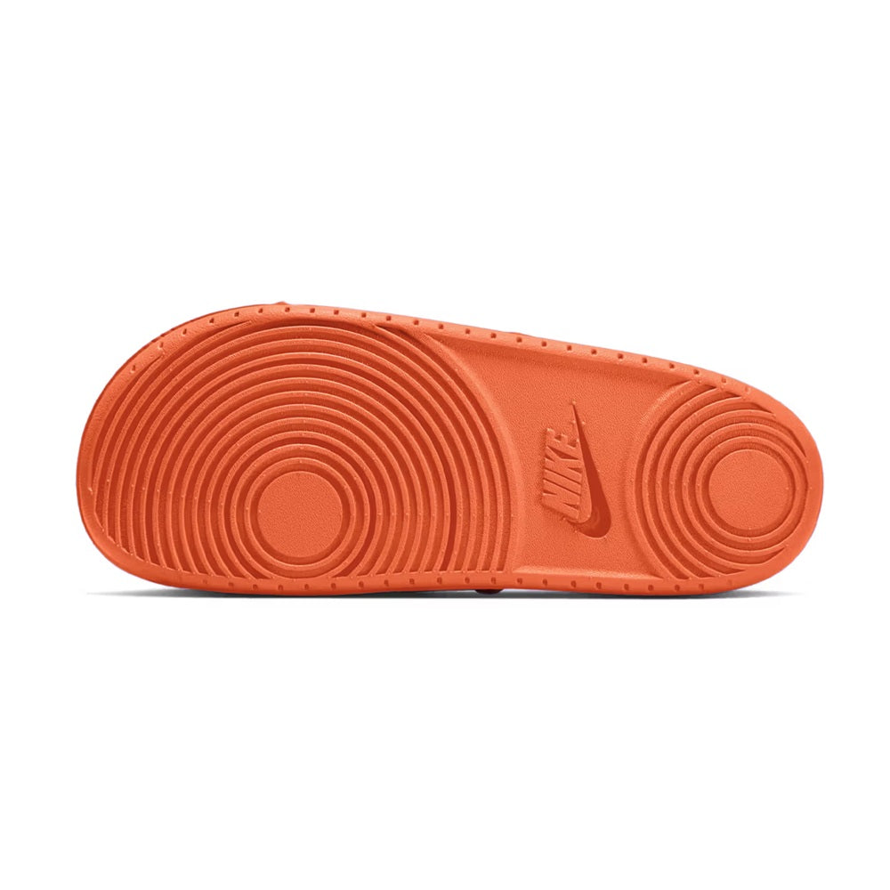 Men's orange slide sandal outsole, circular traction grooves and Nike logo.