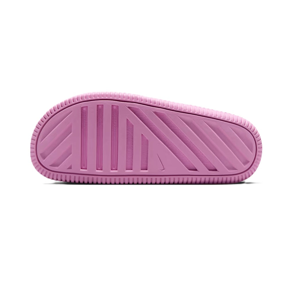Pink outsole view of kids slide sandals with textured traction pattern