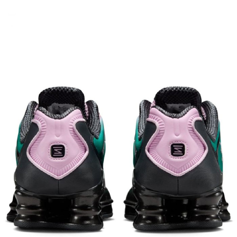 Nike Shox TL fade heel view sneakers with pink pull tabs, black heel, and teal accents