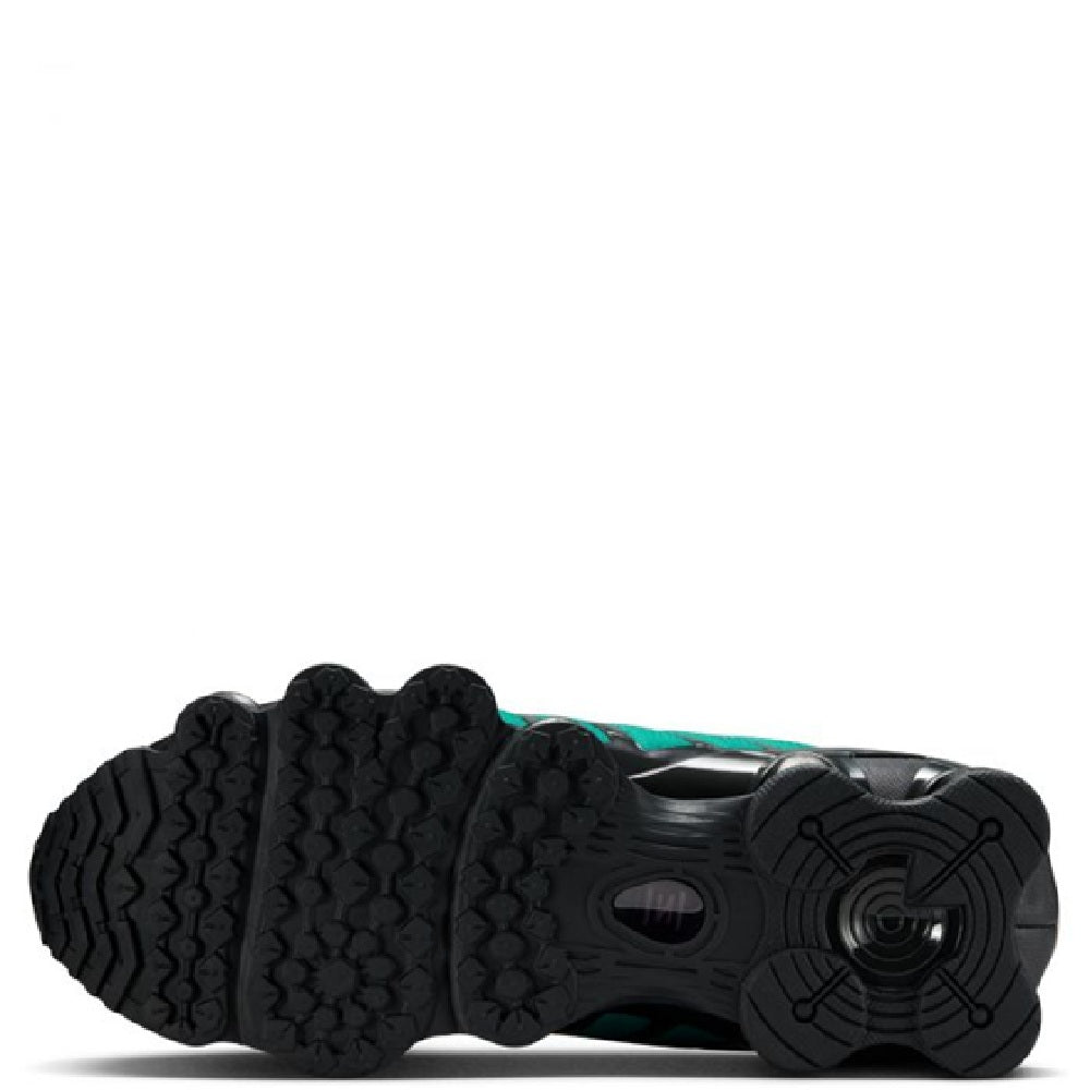 Nike Shox TL fade outsole view with black traction pods and teal midfoot panel