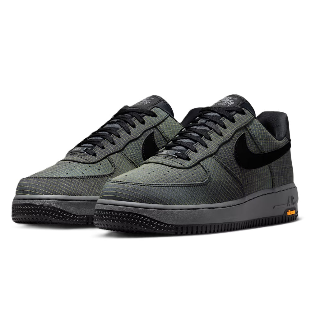 Pair of men's Nike Air Force 1 low-top sneakers with black laces and patterned toe