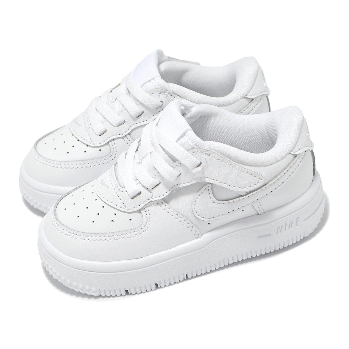 White toddler sneakers, pair with lace-up tongues and Swoosh side panels