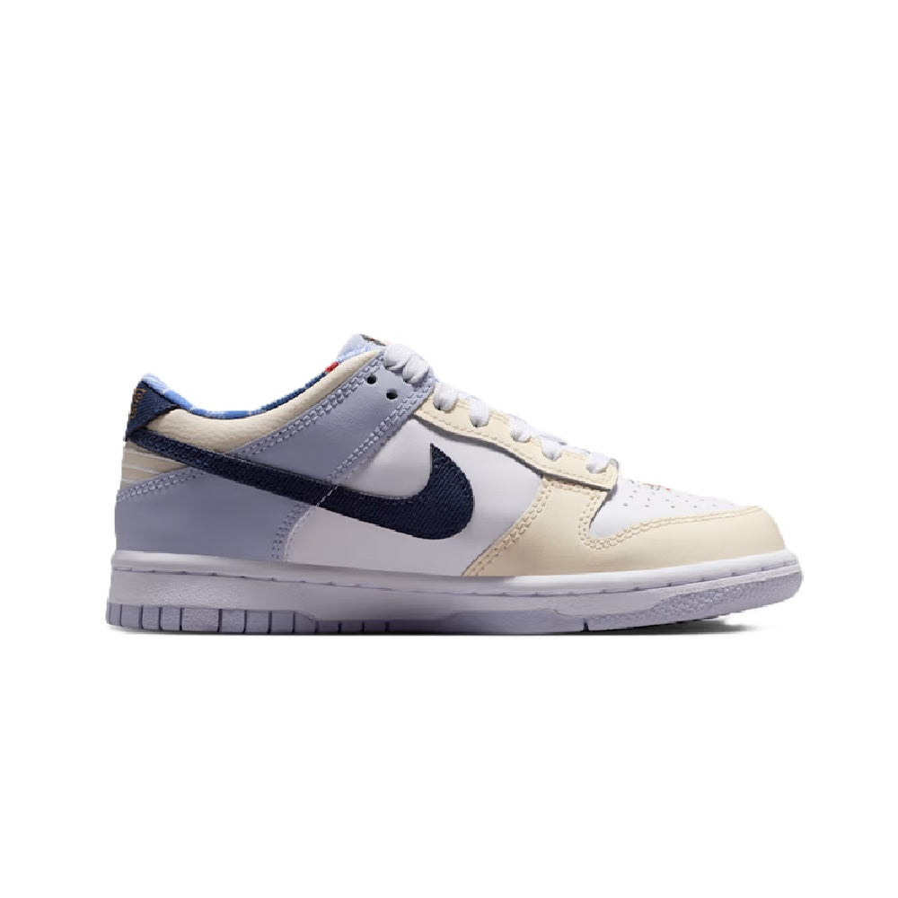Kids' Nike Dunk Low low-top sneakers, side view with white leather and navy Swoosh