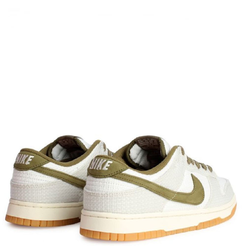 Nike Dunk Low Retro SE sneakers, off-white with olive heel tab and gum outsole.
