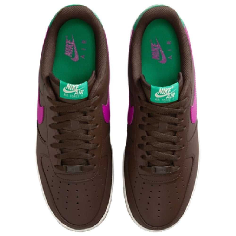 Pair of brown sneakers with green inner lining and Nike Air tongue label