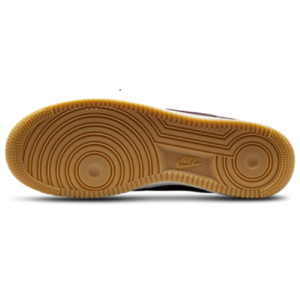 Gum rubber outsole on brown low-top Nike sneakers with circular traction pattern