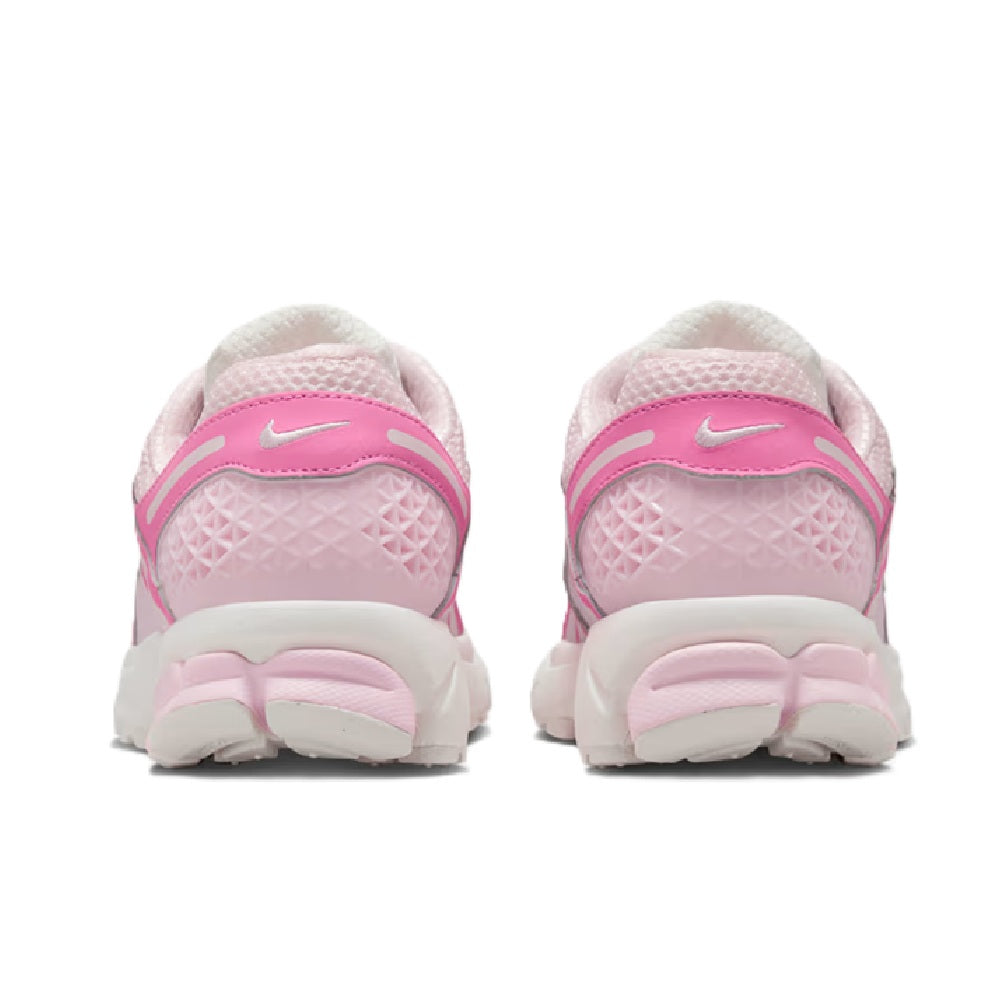 Women's Nike Zoom Vomero 5 sneakers, rear view with pink heel panels and white midsole.