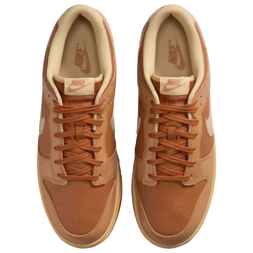 Nike Dunk Low low-top sneakers, front view with brown laces and light cream lining