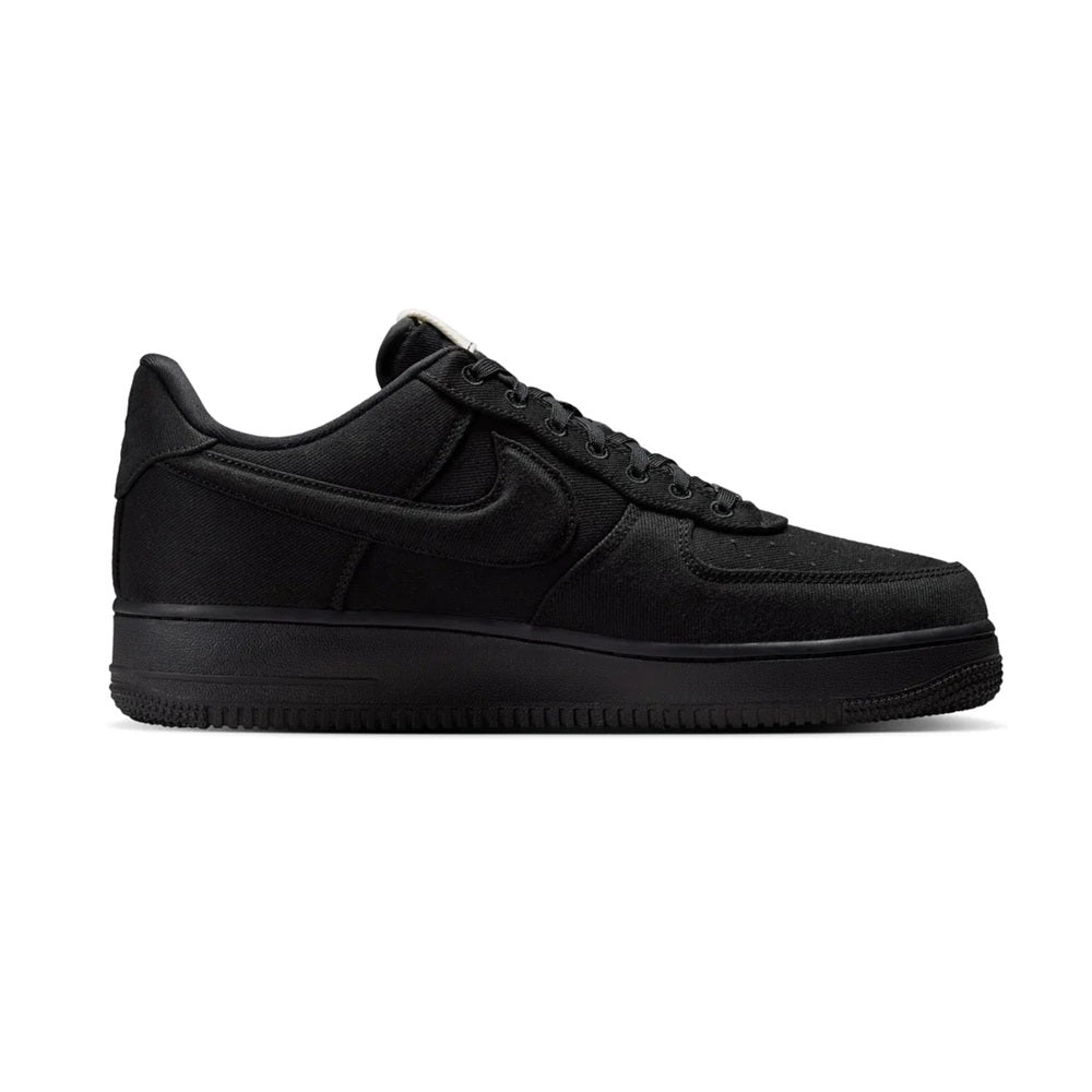 Black low-top Nike Air Force 1 sneakers, angled side profile with textured sole