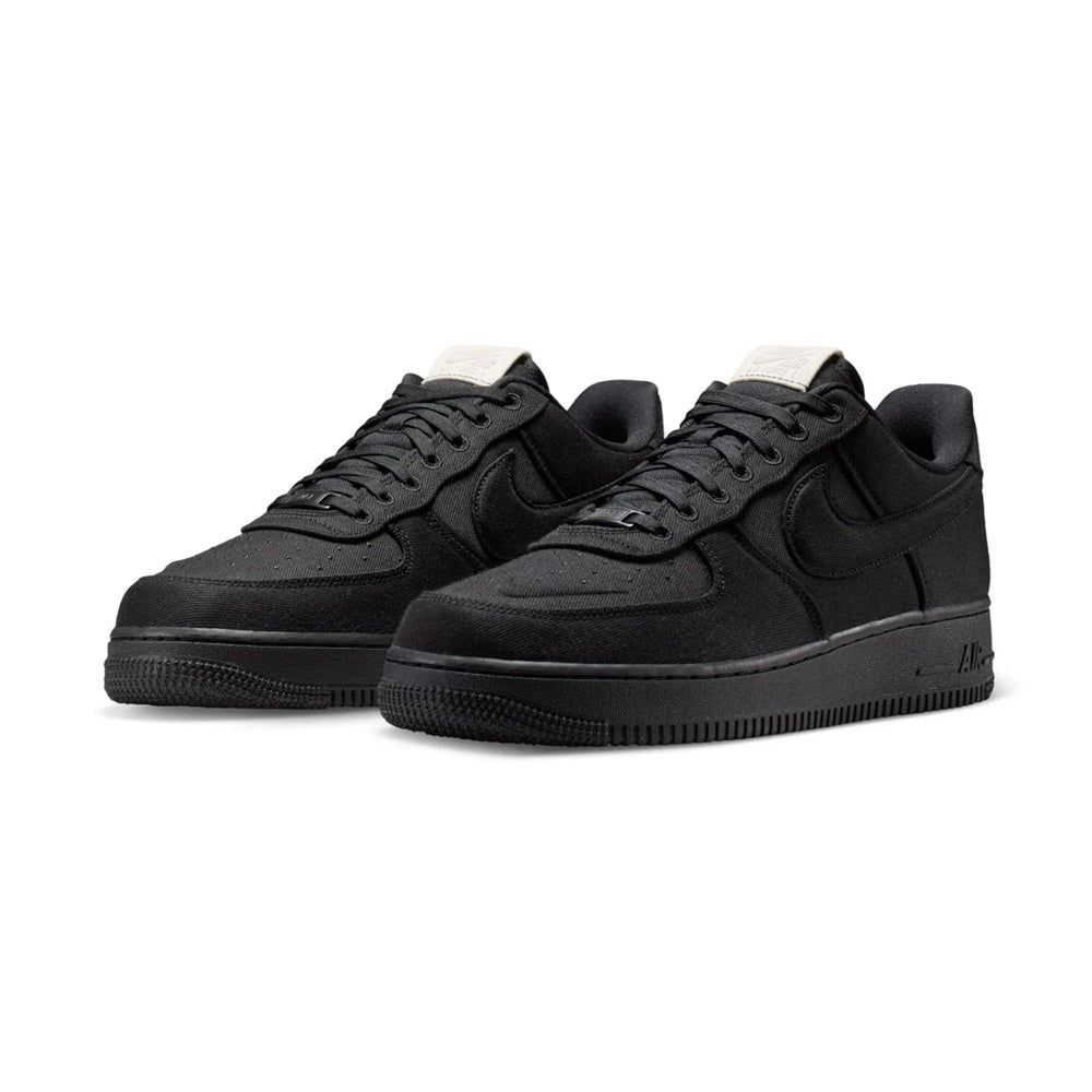 Black low-top Nike Air Force 1 sneakers, front view with off-white heel tabs