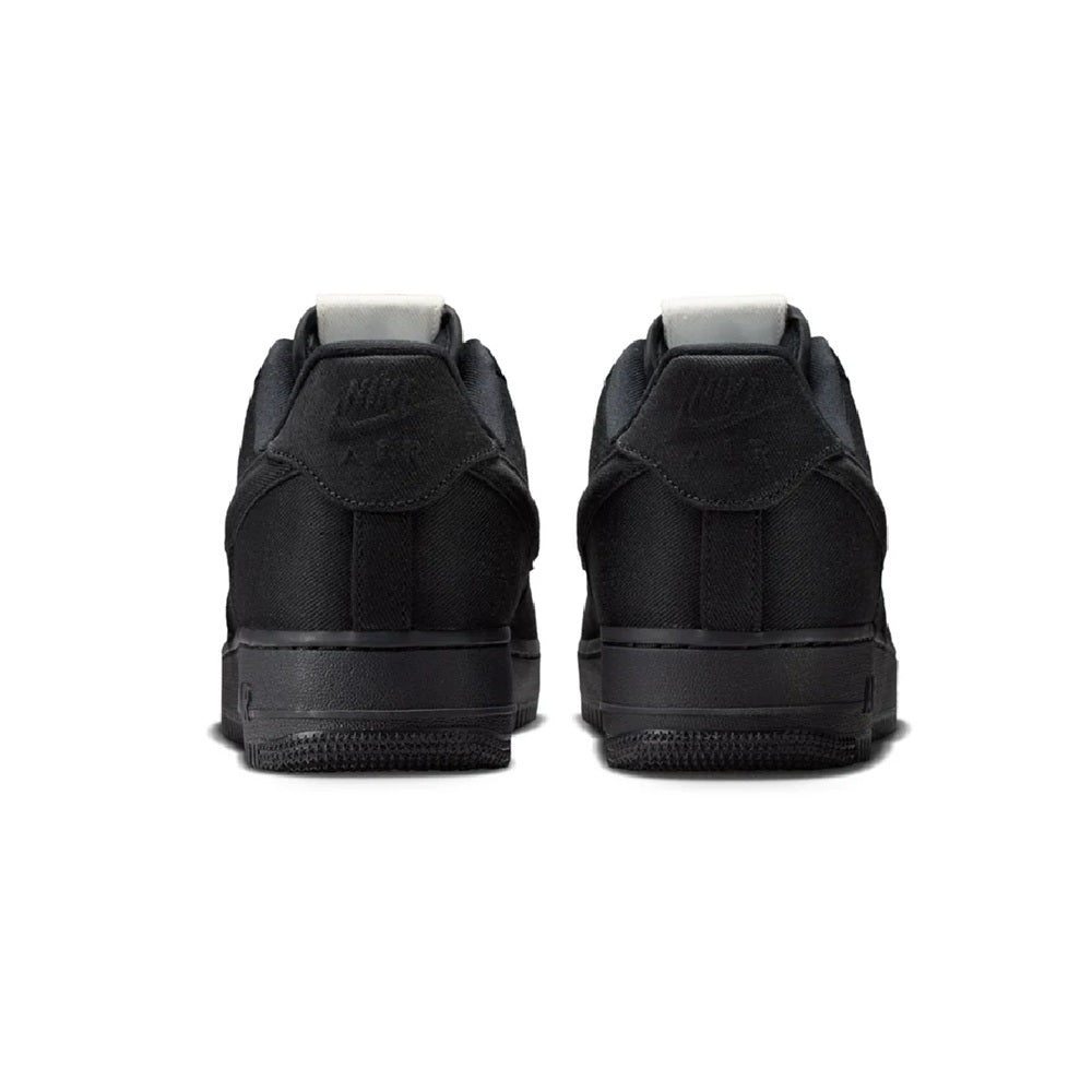 Black Nike Air Force 1 sneakers, rear view with cushioned heel and lace collar