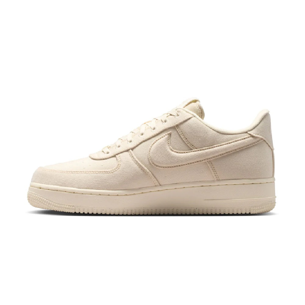 Beige Nike Air Force 1 low-top sneaker angled side view, lace-up with swoosh
