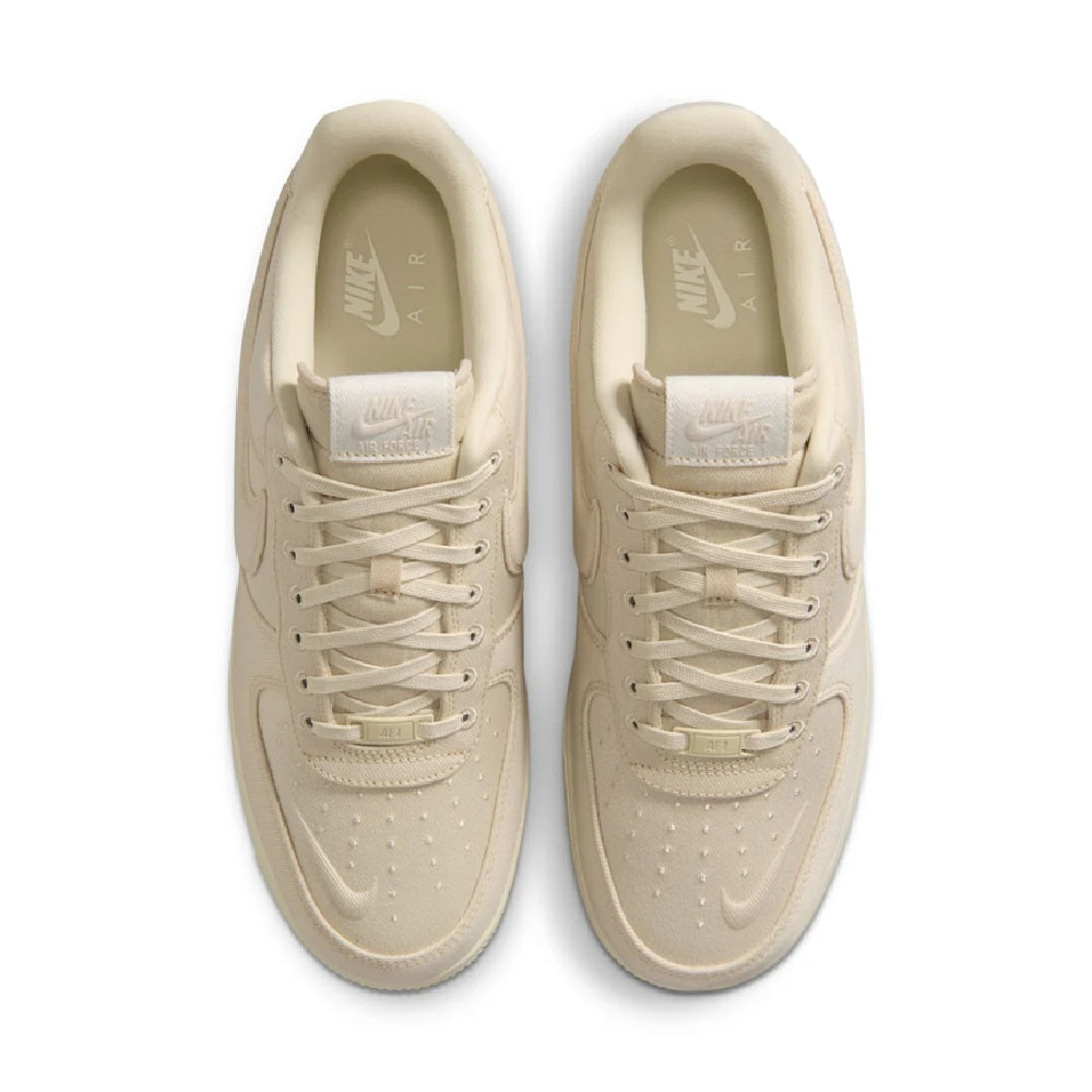 Beige Nike Air Force 1 sneakers, pair with laces and visible tongue label