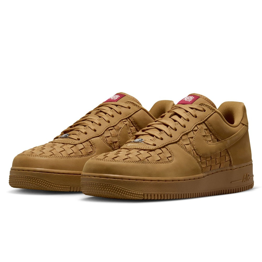 Nike Air Force 1 Low PRM sneaker pair, wheat tan uppers with red tongue labels