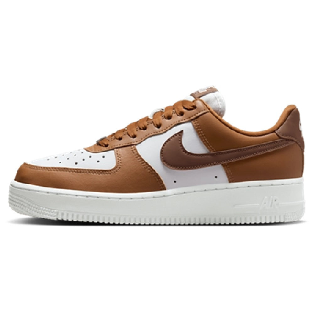 Tan, brown, and white low-top sneakers with Nike swoosh and lace-up eyelets