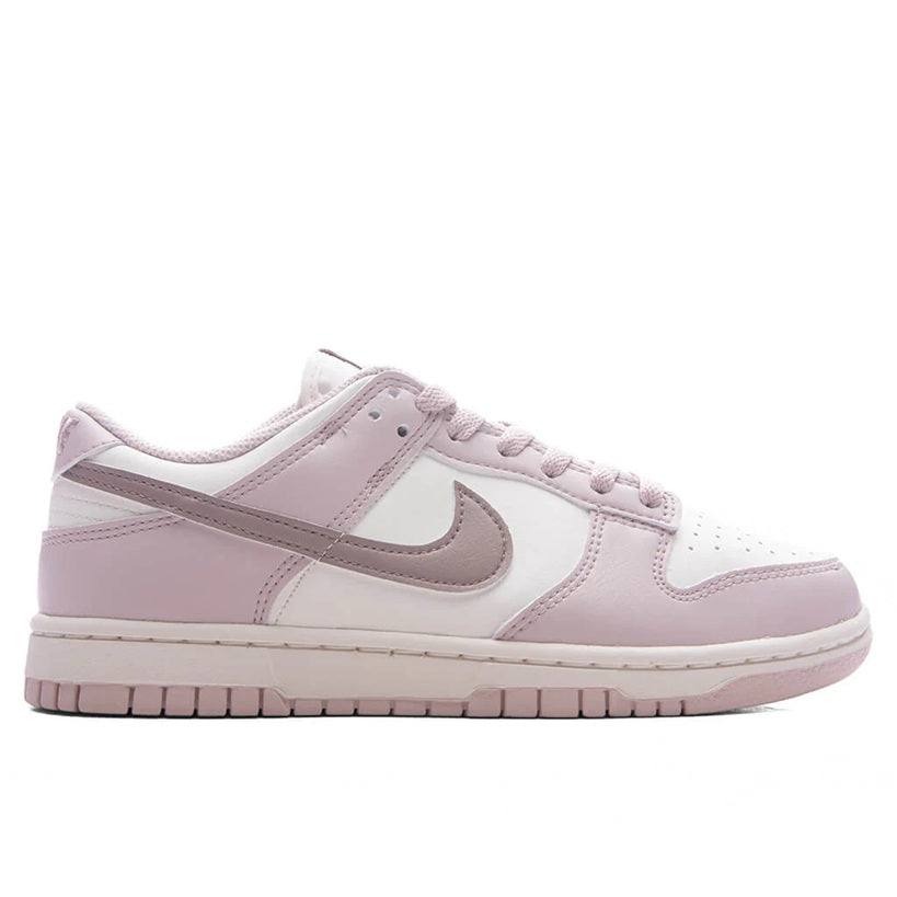 Low-top Nike sneakers in pale pink and white, lace-up with swoosh side panels.