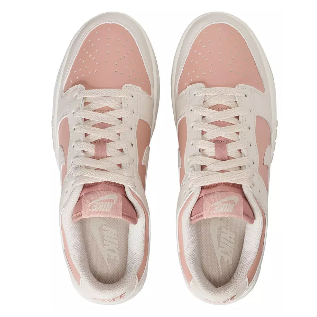 Nike Dunk Low sneakers, front view with white toe box, pink tongue lining, lace-up