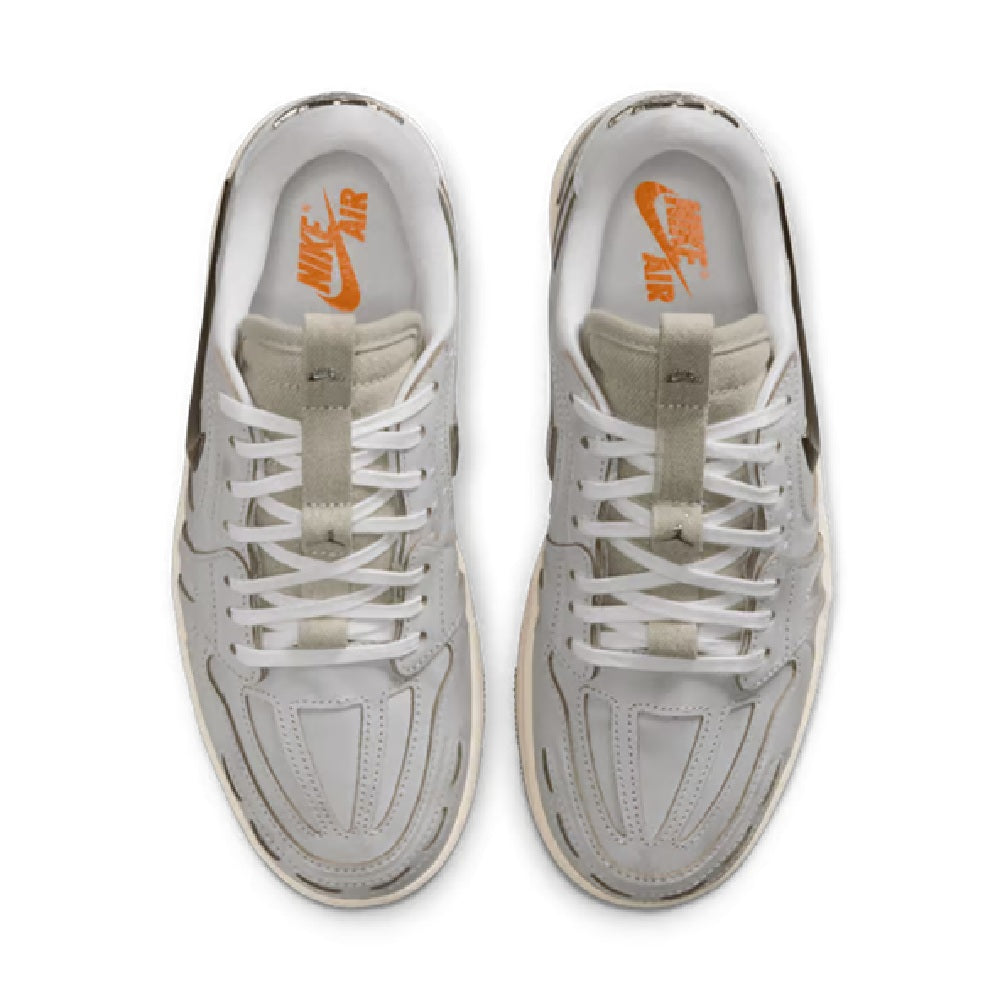 Pair of white low-top sneakers showing orange Air branding inside