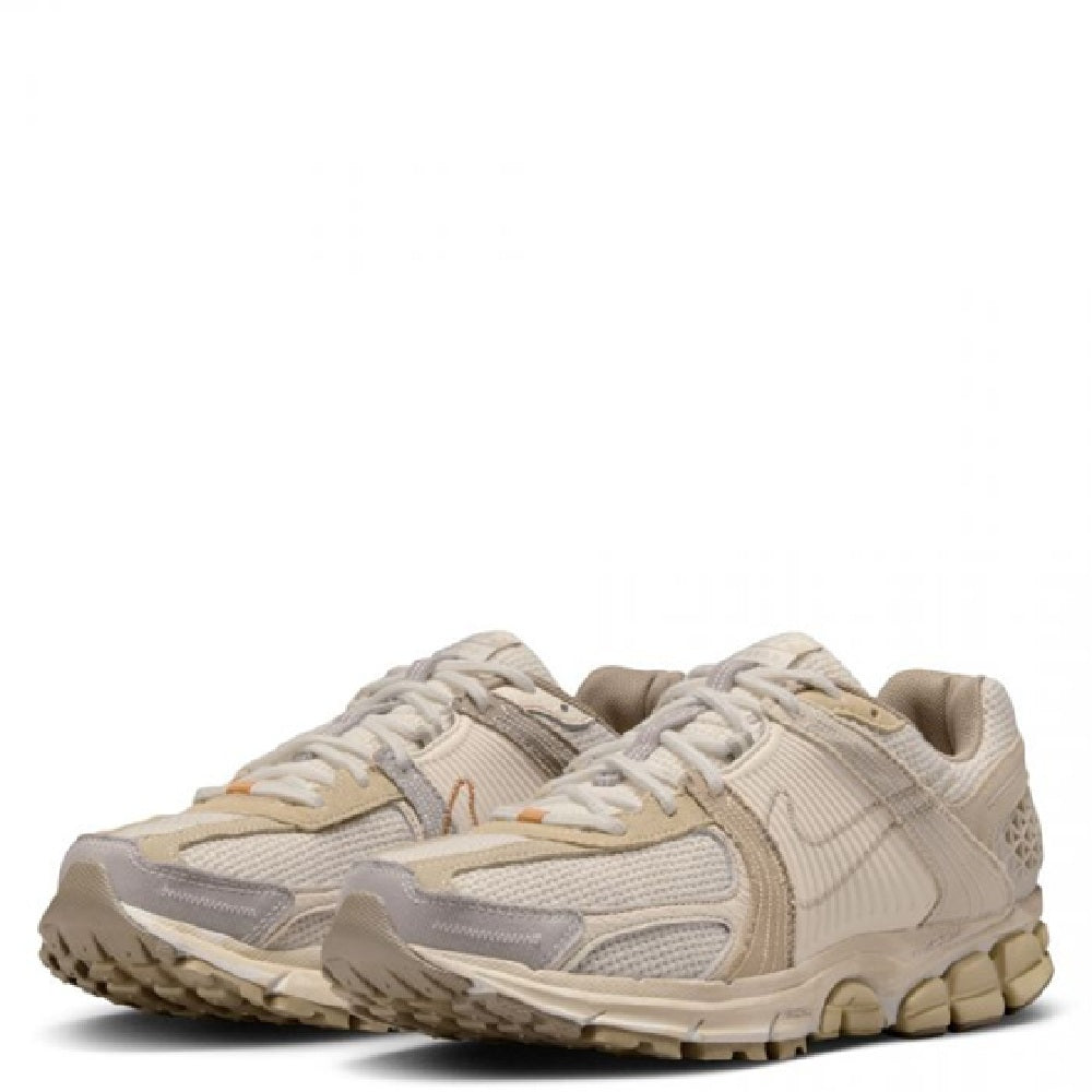 Cream and tan Nike Zoom Vomero 5 LT sneakers with orange accents and cushioned sole