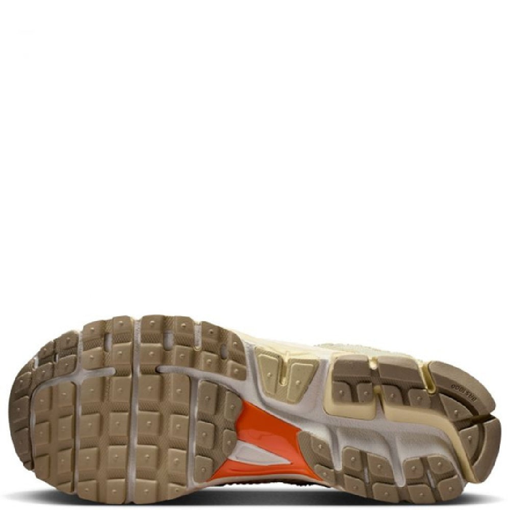 Outsole view of Nike Zoom Vomero 5 LT sneakers with grippy tread and orange insert