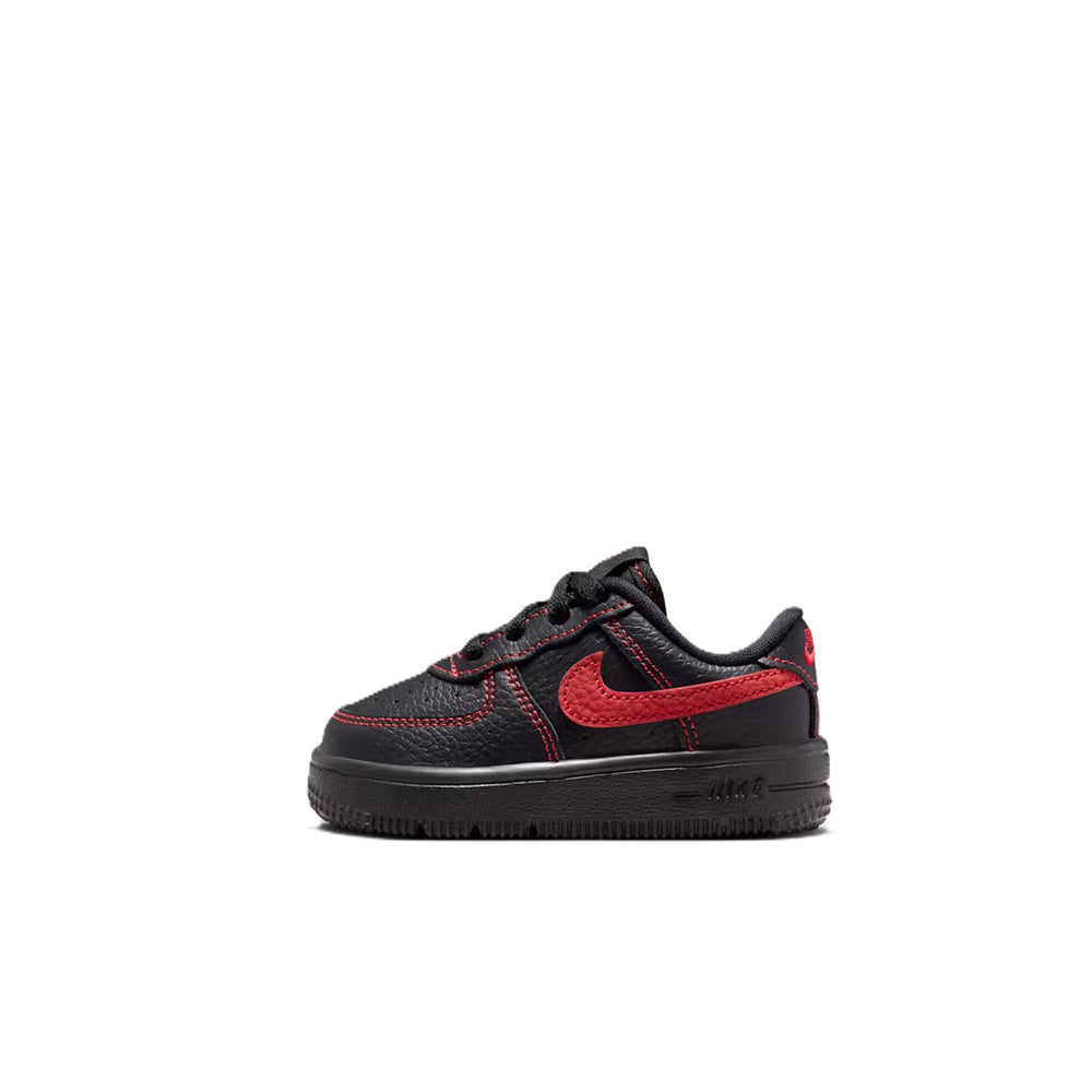 Toddler low-top lace-up sneakers, black upper with red panels and swoosh.