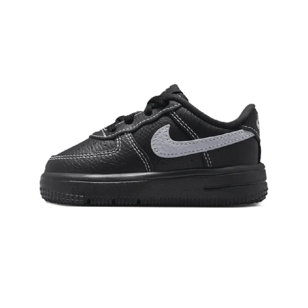 Kids' Nike Force 1 Low sneakers, black leather look with light gray swoosh panel.