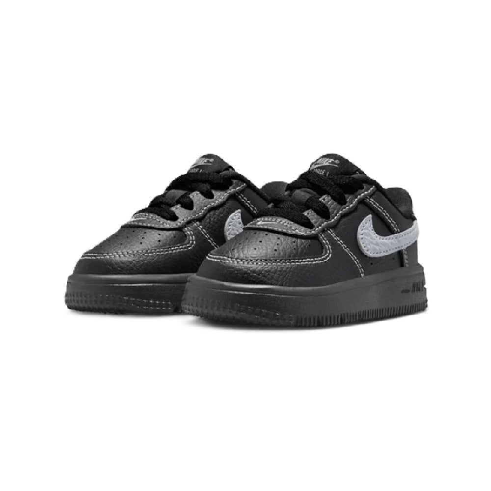 Kids' Nike Force 1 Low sneakers pair, black uppers with light gray swooshes.