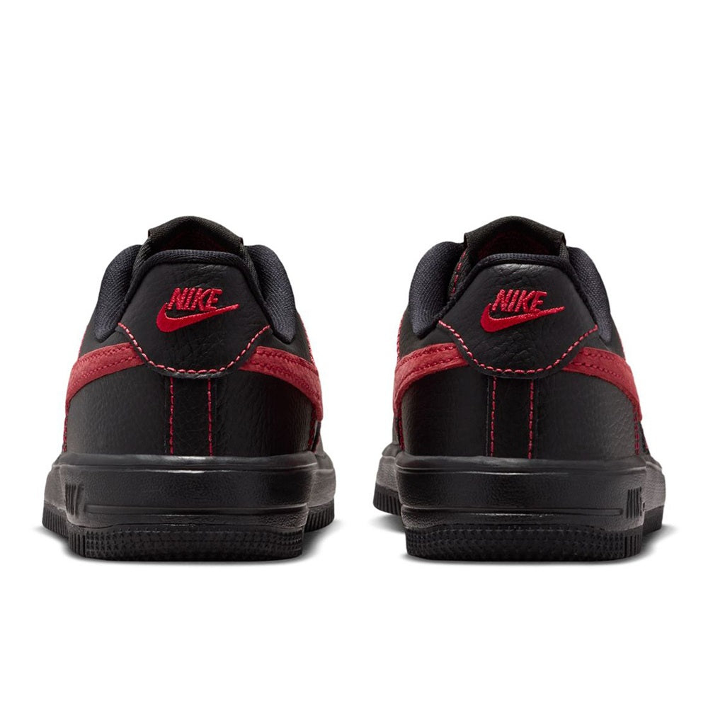 Back view of kids' Nike Force 1 sneakers, black uppers with red heel overlays