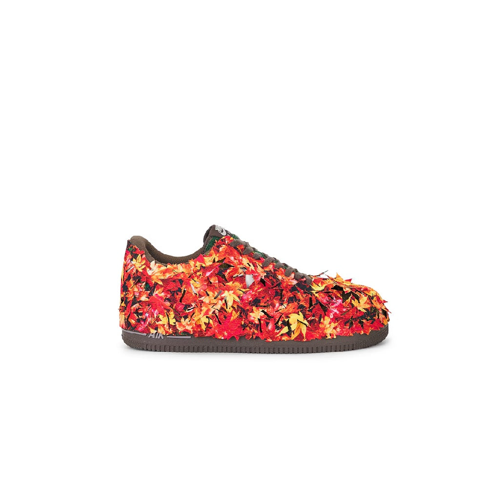 Red, orange, and yellow low-top sneakers with dark rubber sole and lace-up front
