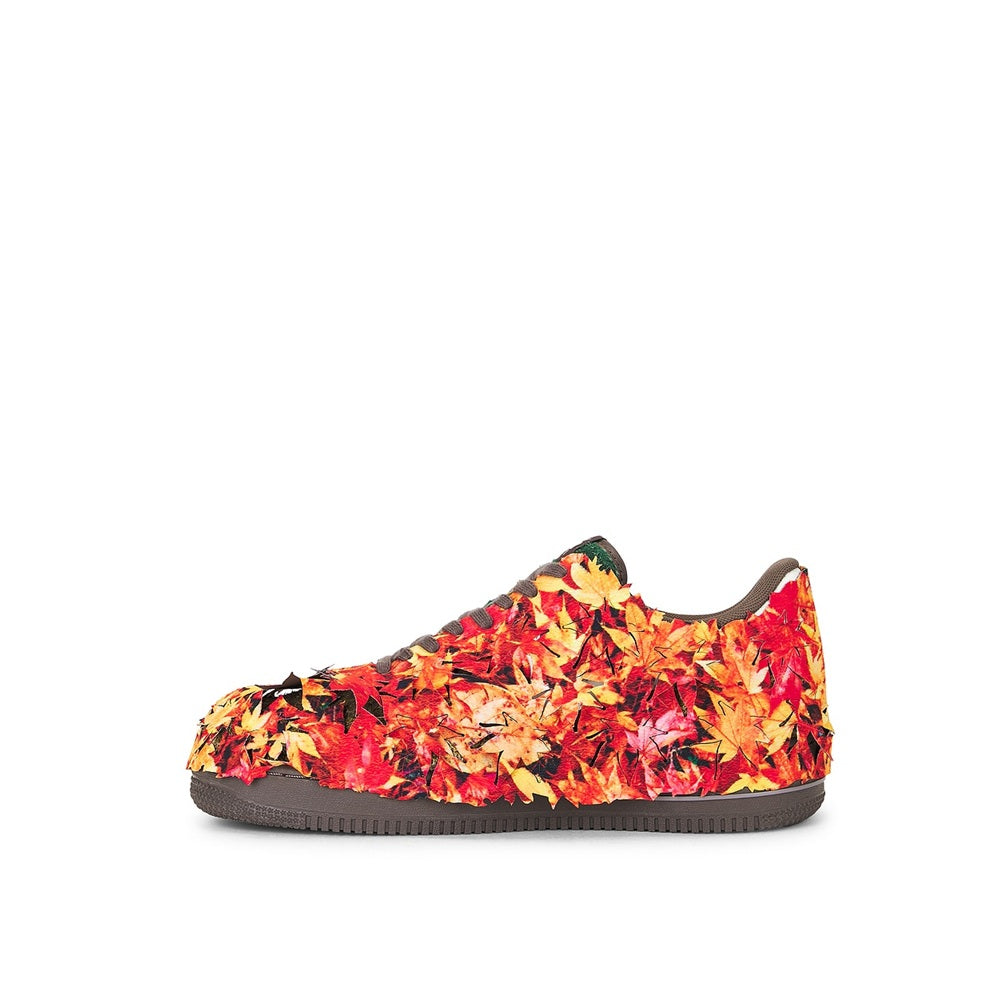 Side view low-top sneakers with red, orange, and yellow patterned upper, dark sole