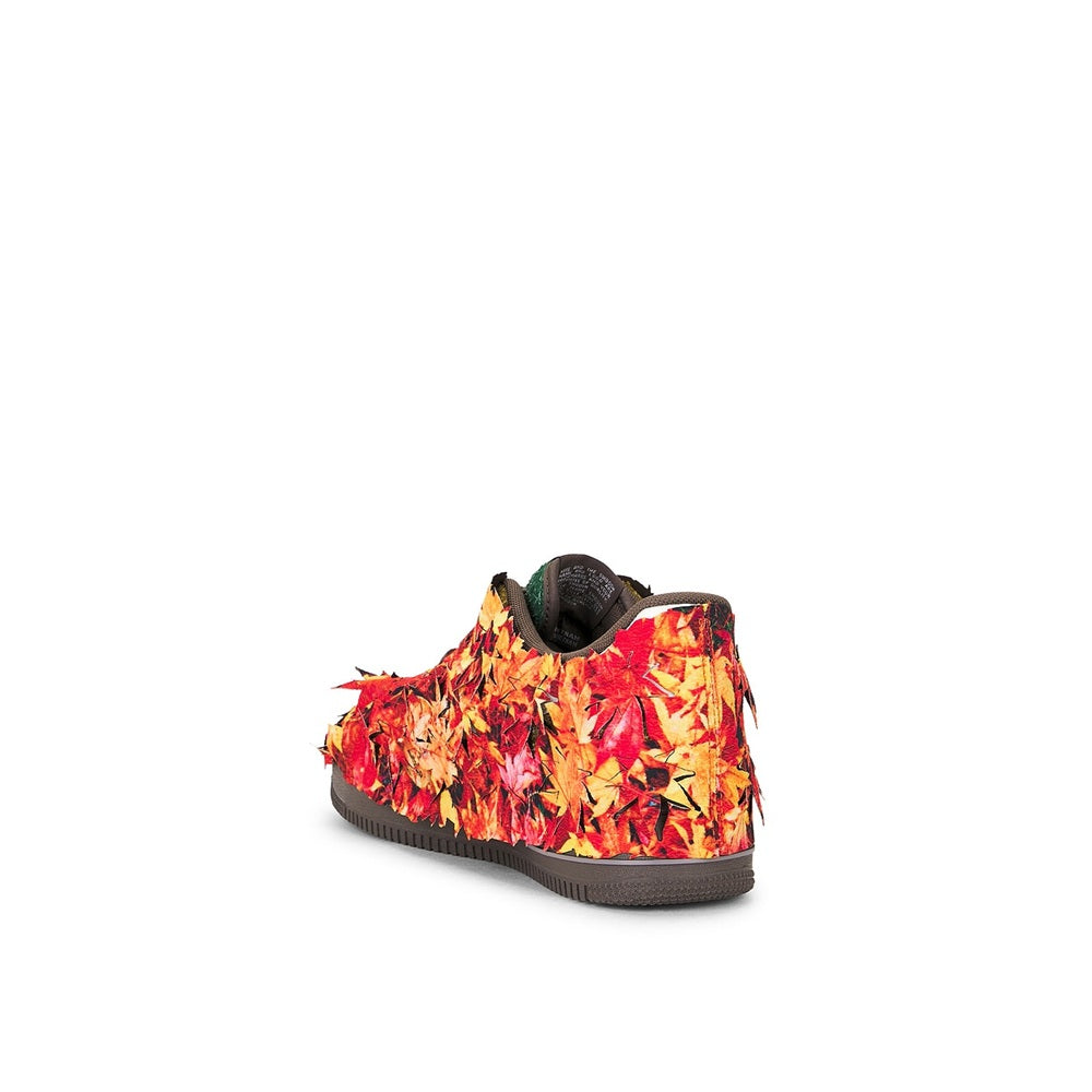 Back view low-top sneakers in red, orange, and yellow pattern with dark heel tab