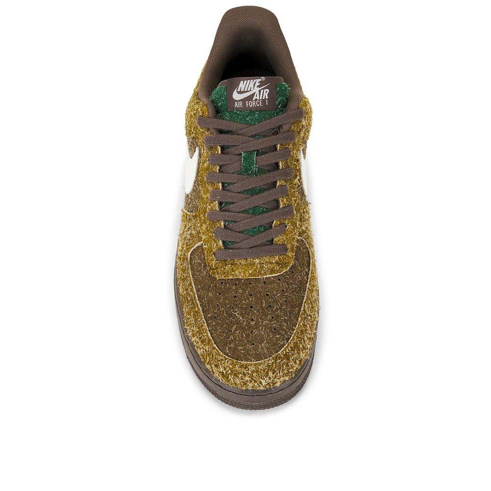 Front view low-top sneakers with gold textured upper and dark green lace-up